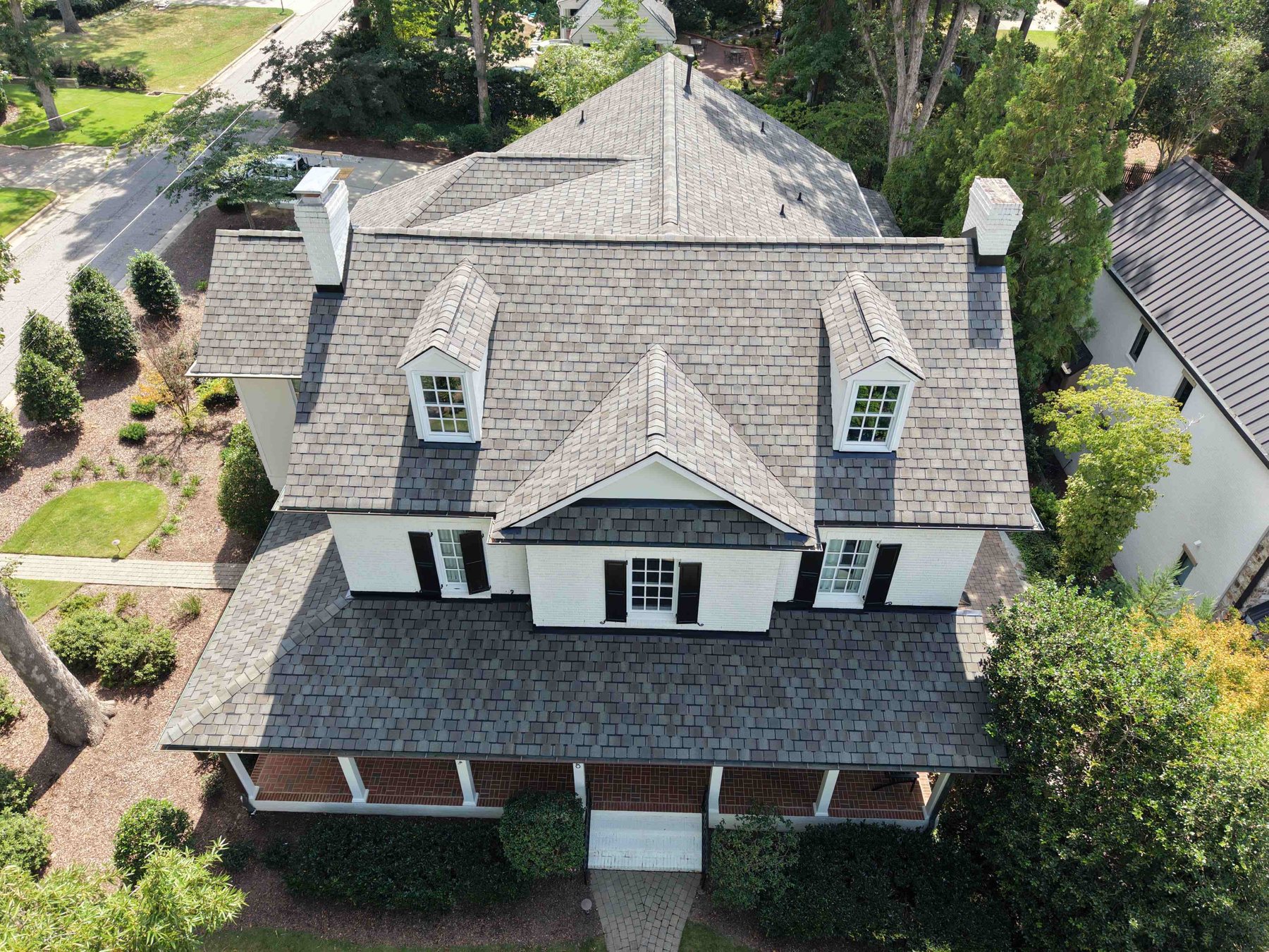 Roof Replacement by Emerald Roofing using Completed roof on a brick colonial, from above