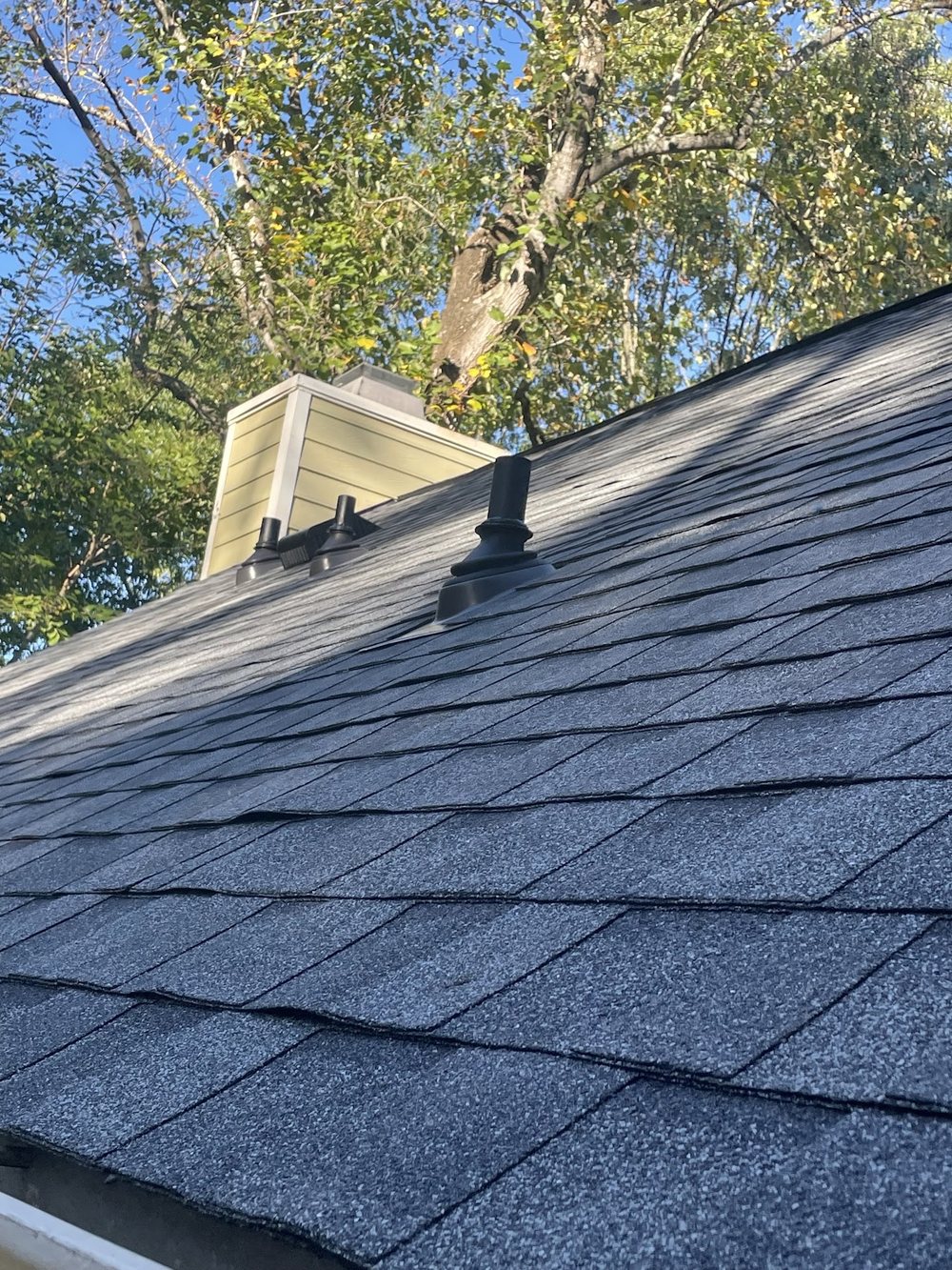 Roof Replacement by Emerald Roofing using New architectural shingles and chimney flashing