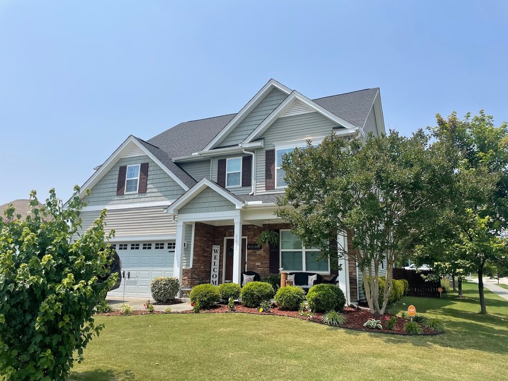 Completed architectural shingle roof on a stone and shake Triangle home by Emerald Roofing