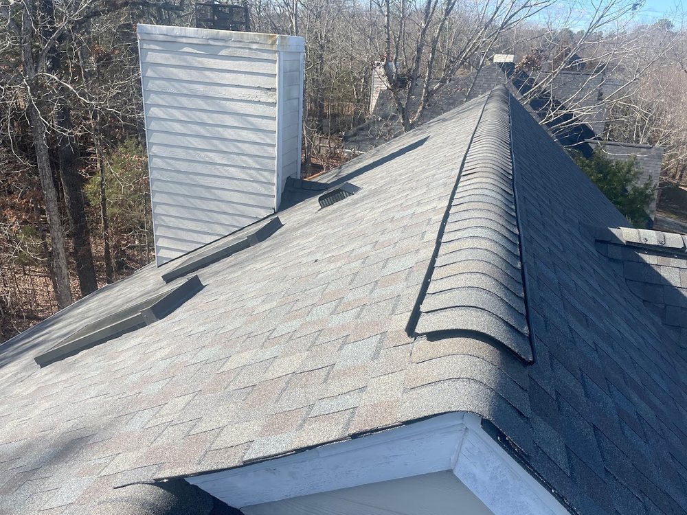 Roof Inspection by Emerald Roofing using Aged shingles and chimney flashing seen from above