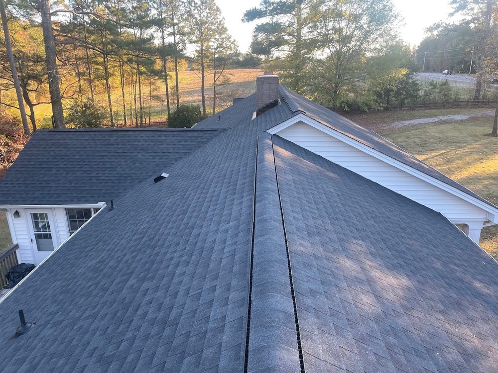 Roof Replacement by Emerald Roofing using Completed roof at golden hour