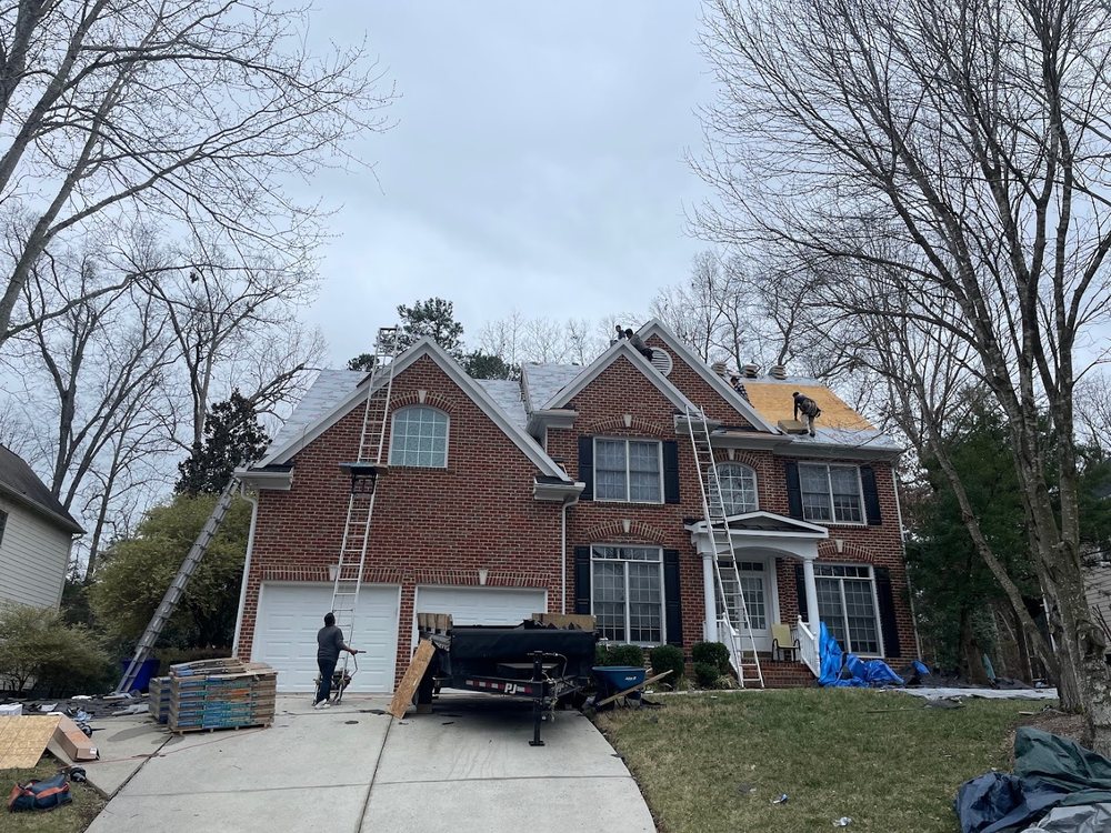 Roof Replacement by Emerald Roofing using Crew replacing a brick colonial roof