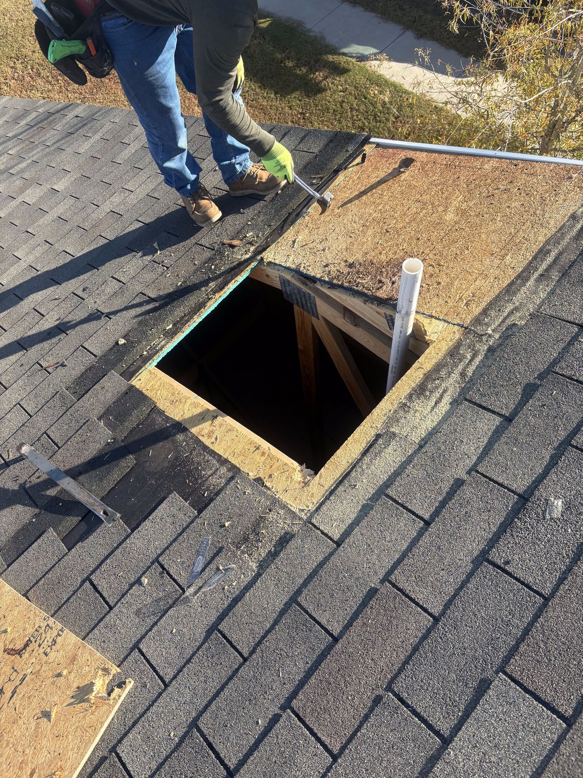 Roof Repair by Emerald Roofing using Failed roof decking cut out, rafters exposed