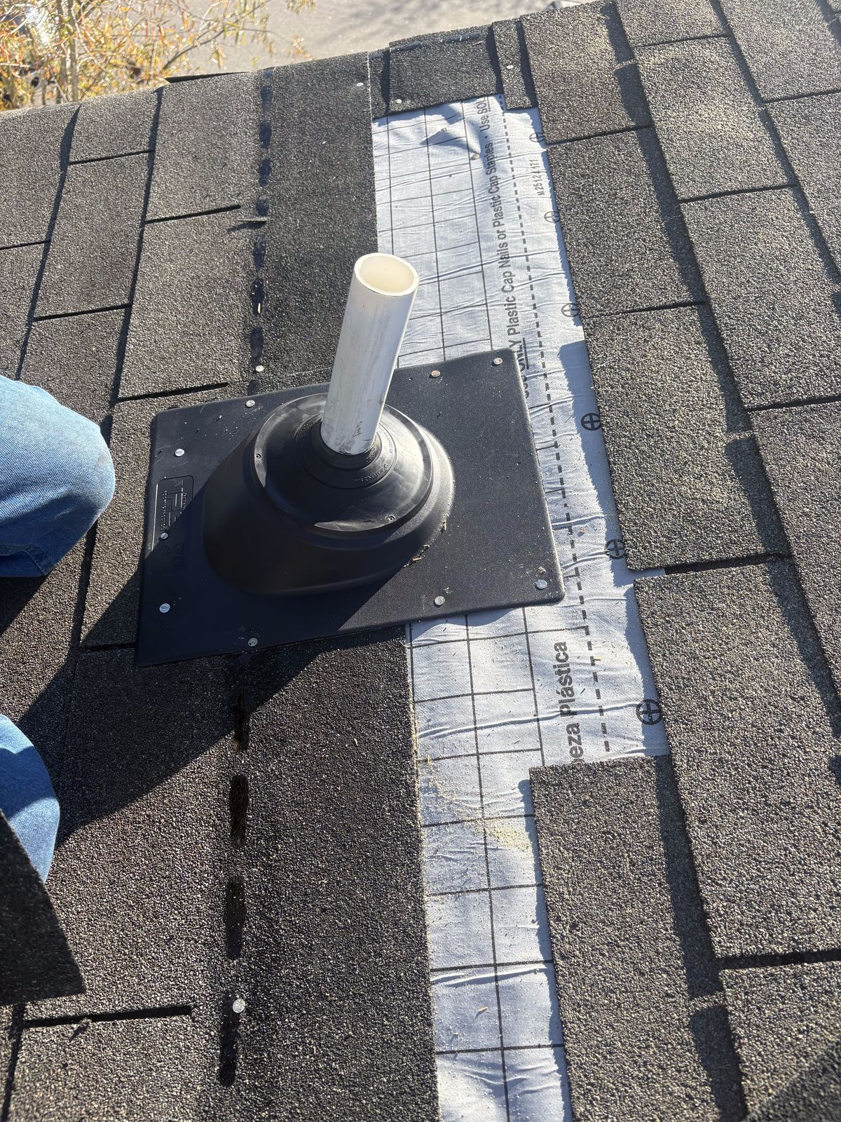 Roof Repair by Emerald Roofing using New pipe boot and flashing plate set over the underlayment