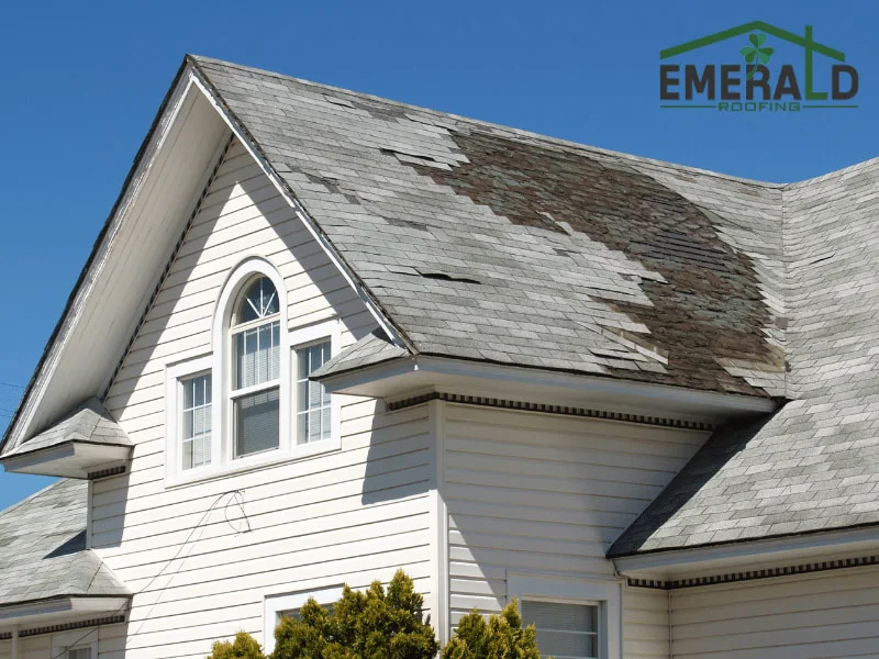 Storm damaged asphalt shingle roof with missing and deteriorated shingles on a residential home in Raleigh NC
